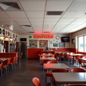 Interior view of a Hooters restaurant with memorabilia.