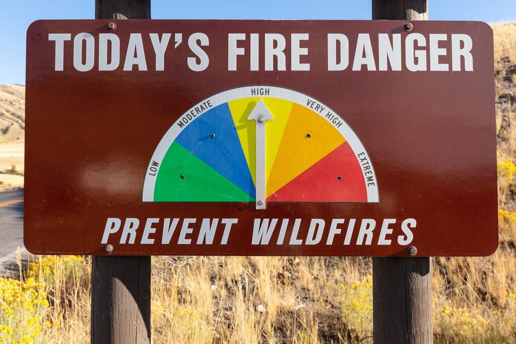 A roadside Today's Fire Danger sign with the arrow pointing to High