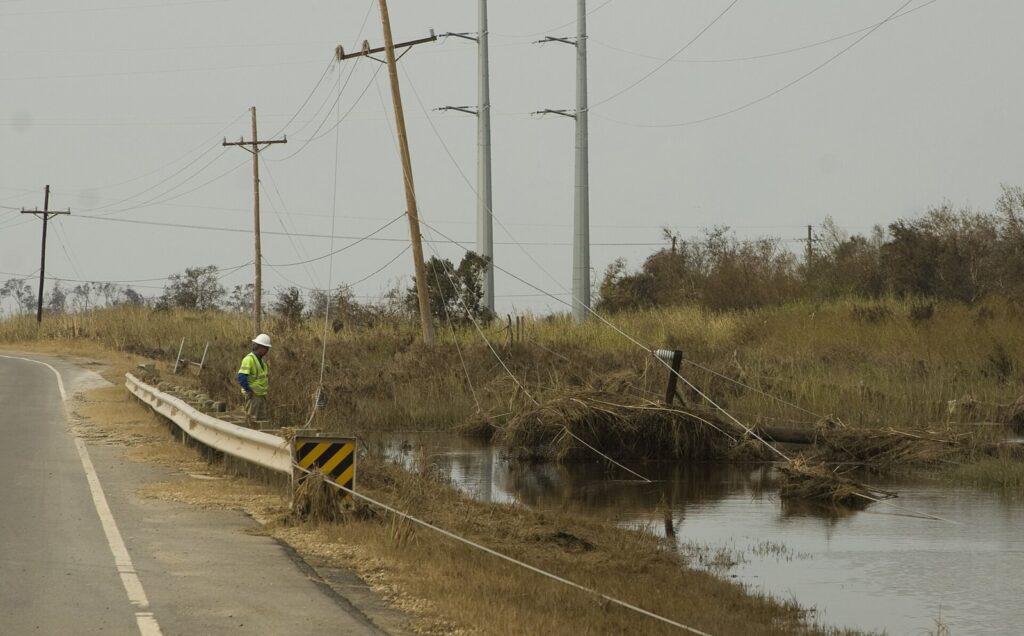 Utility lineman checking downed power lines